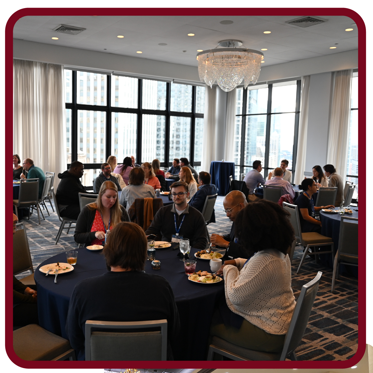 Attendees network and share discussions during a Rego University conference meal