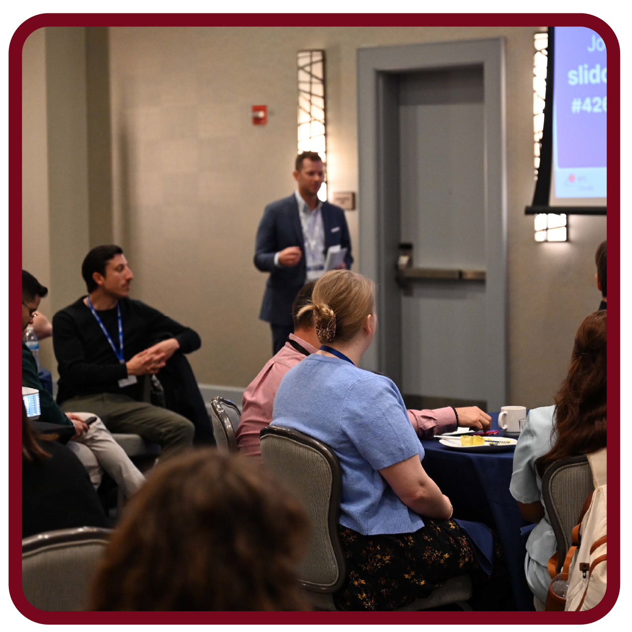 Presenter leads a Rego University session and interacts with attendees