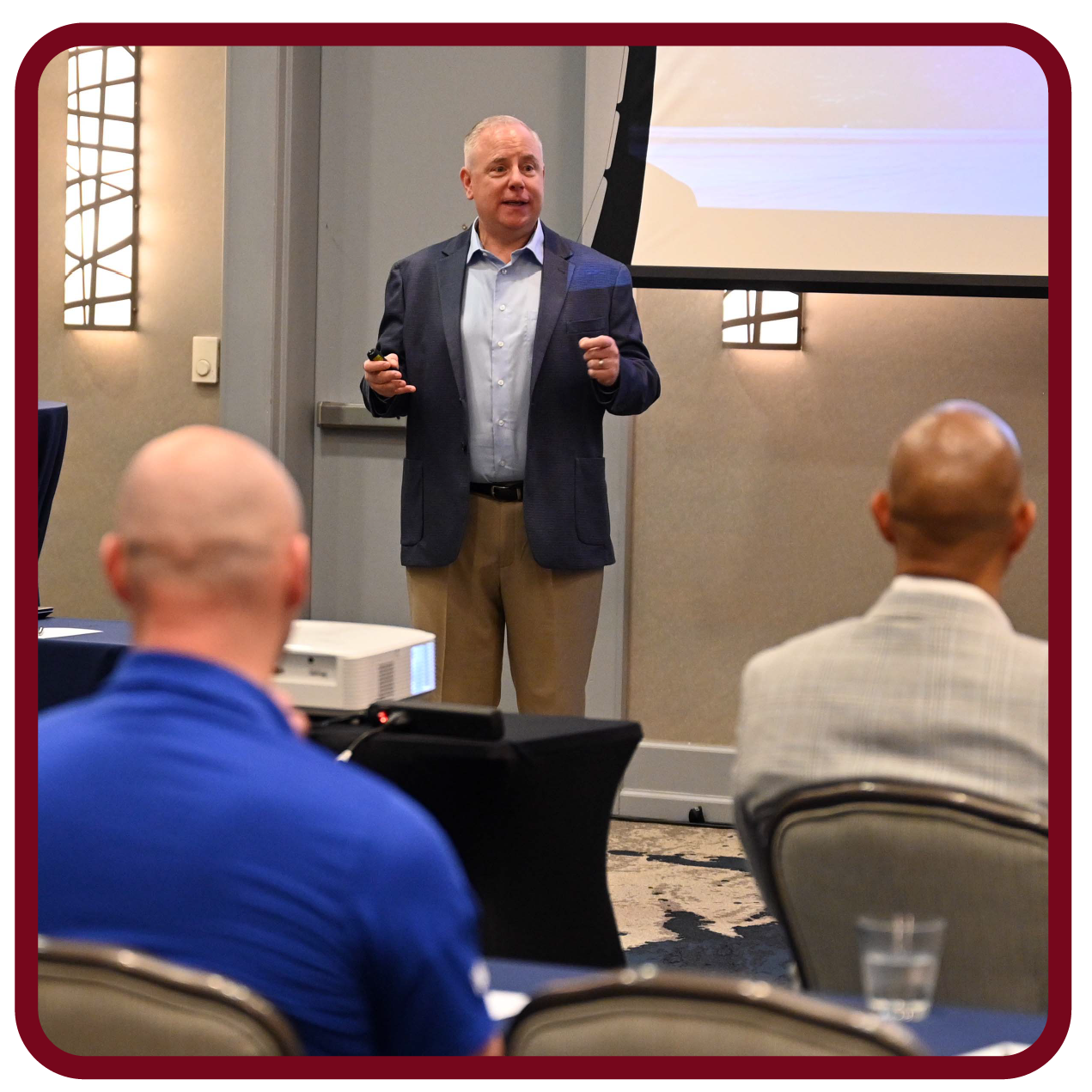 Presenter speaks to Rego University attendees