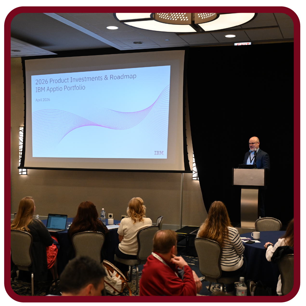 Presenter delivers an IBM Apptio roadmap session while attendees follow the presentation and discussion.